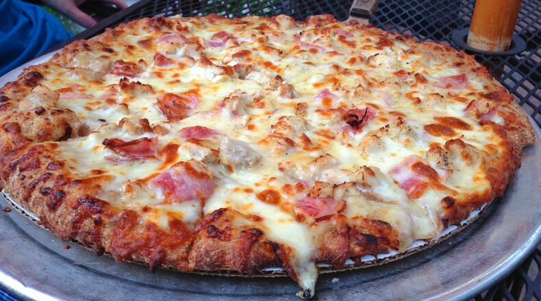 Look at that melty cheese! Chicken Cordon Bleu gourmet pizza is made by scratch and baked in a stone oven at South Park Tavern. (Staff photo by Connie Post)