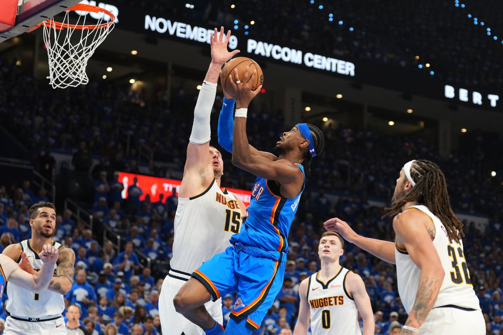 Oklahoma City Thunder guard Shai Gilgeous-Alexander (2) shoots as Denver Nuggets' Nikola Jokic (15) defends in the second half of Game 7 in the Western Conference semifinals of the NBA basketball playoffs, Sunday, May 18, 2025, in Oklahoma City. (AP Photo/Kyle Phillips)