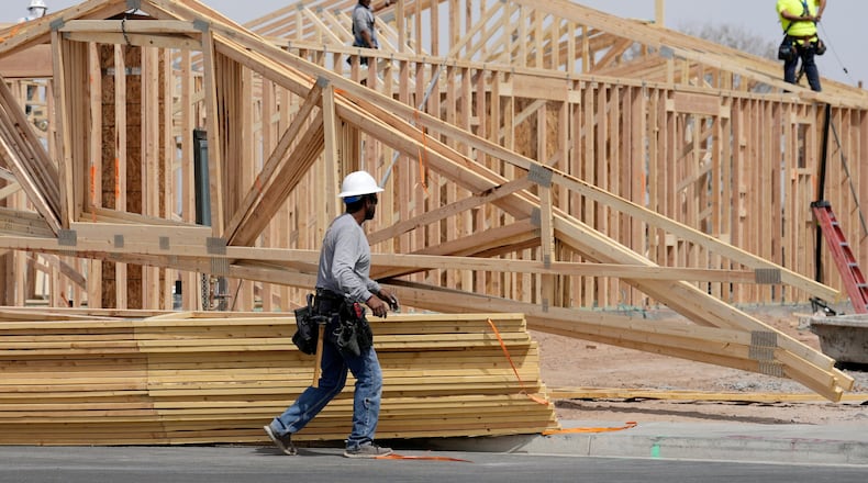 FILE - Construction workers install a lumber roof at a new home build Tuesday, April 1, 2025, in Laveen, Ariz. (AP Photo/Ross D. Franklin, File)