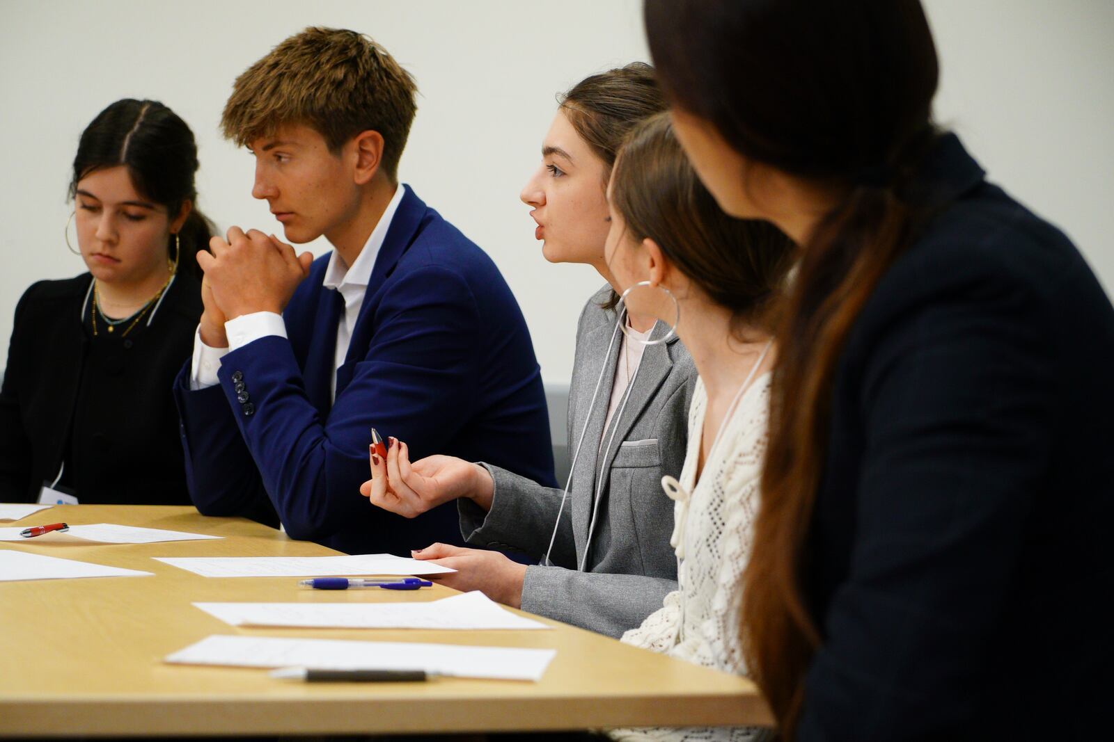 Student Zelda Lerner, center, makes a point during a semifinal round of the National High School Ethics Bowl in Chapel Hill on Sunday, April 13, 2025. (AP Photo/Allen G. Breed)