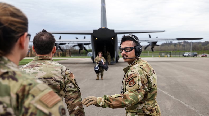 Tech. Sgt. Diego Weithoener, right, 445th Aeromedical Evacuation Squadron medical technician, directs U.S. Air Force critical care air transport teams (CCATTs) back to the aircraft to offload mannequin patients at the Cincinnati Municipal Airport, April 6. The CCATTs trained with the 445th Aeromedical Evacuation Squadron on trauma and critical care aboard an aircraft as part of the Center for the Sustainment of Trauma and Readiness Skills (C-STARS) program at the University of Cincinnati Medical Center. (U.S. Air Force photo by Master. Sgt. Patrick O’Reilly)