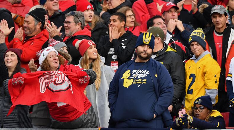 COLUMBUS, OH - NOVEMBER 24:  Ohio State fans celebrate in the fourth quarter after the Buckeyes added another touchdown as Michigan Wolverines fans watch at Ohio Stadium on November 24, 2018 in Columbus, Ohio. Ohio State defeated Michigan 62-39.  (Photo by Jamie Sabau/Getty Images)