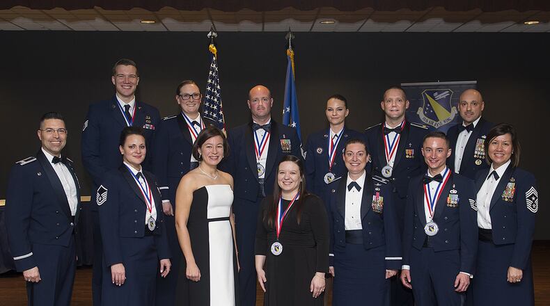 Winners of the 88th Air Base Wing annual awards pose with Col. Thomas P. Sherman (left), 88 ABW and installation commander, and Chief Master Sgt. Stephen A. Arbona (top right), 88 ABW command chief, at the 88th Air Base Wing Annual awards banquet Jan. 17 in the Wright-Patterson Club at Wright-Patterson Air Force Base. Top honors were awarded in 10 individual categories and a squadron category. (U.S. Air Force photo/R.J. Oriez)