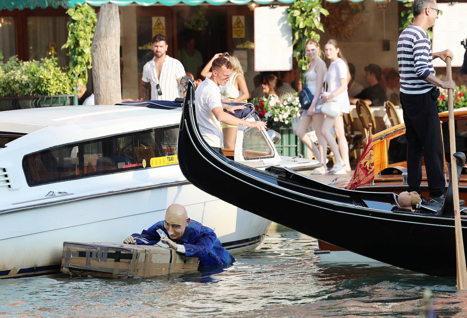 A mannequin resembling Jeff Bezos floats in a canal in Venice, Italy, on Tuesday, June 24, 2025, ahead of festivities in the lagoon city reportedly linked to a wedding celebration for Jeff Bezos and Lauren Sánchez. (Click News via AP)