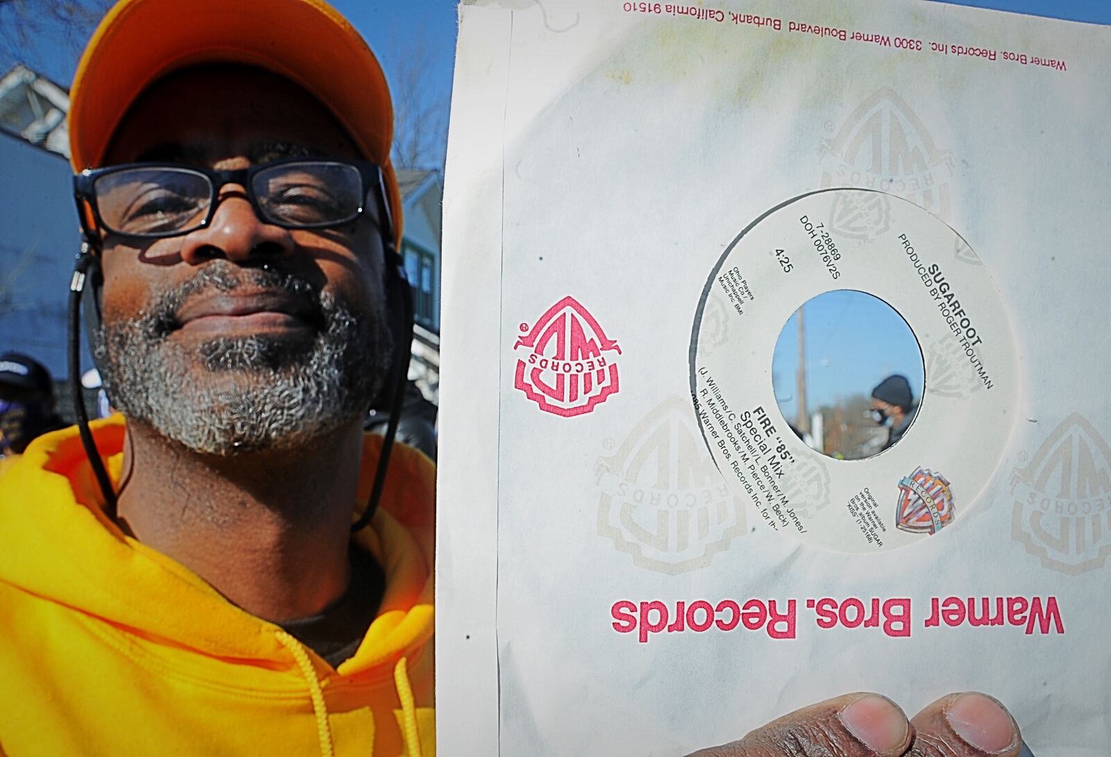 John W. Smith holds up a copy of a record that he received at the ceremony honoring the Ohio Players Friday April 2, 2021. MARSHALL GORBY \STAFF
