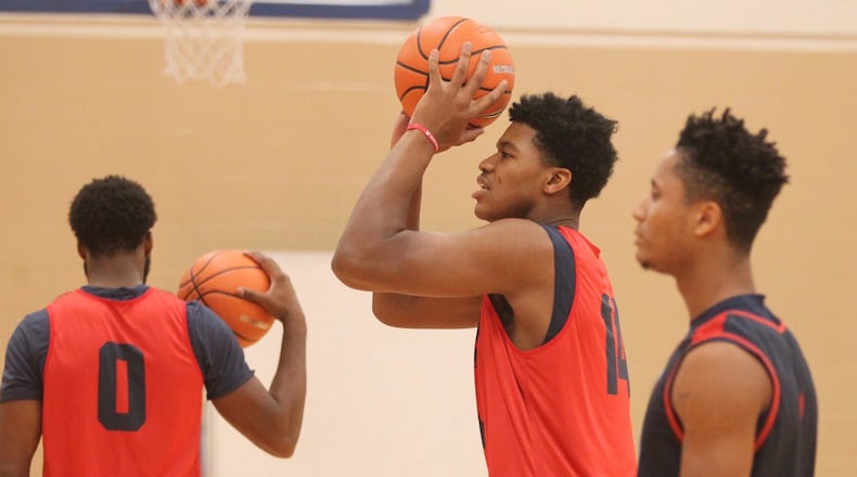 Dayton’s Jordan Pierce shoots at practice in September at the Cronin Center. David Jablonski/Staff