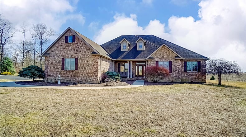 This custom built brick home has three bedrooms and two and a half baths with a full, unfinished basement and a second level loft room.