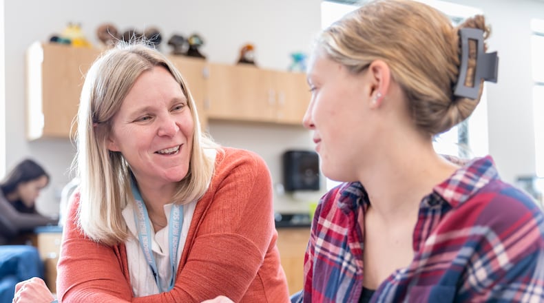 Amanda Spirk, a PLTW biomedical sciences teacher at Fairborn High School, helps student Abby Gumbert with an assignment during a class on Wednesday, Oct. 15. BRYANT BILLING / STAFF