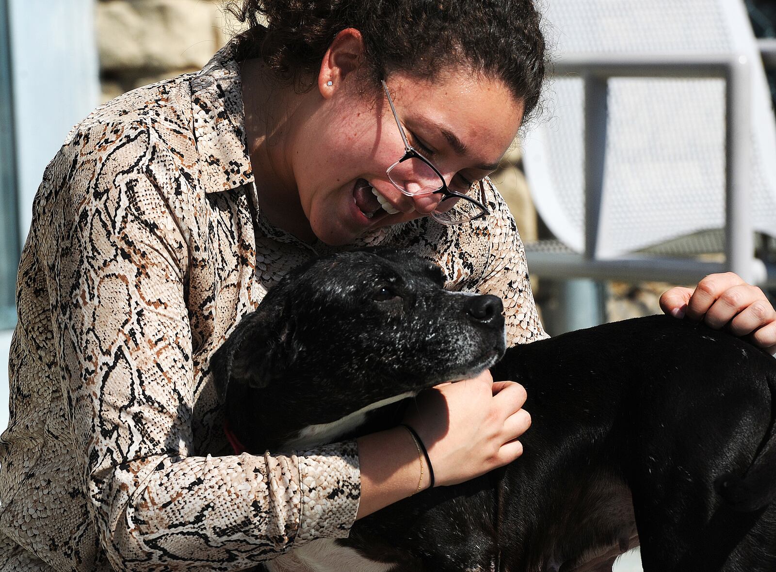 Doolis cuddles against Kara Hamby, a Montgomery County public information officer for the animal resource center.  MARSHALL GORBY\STAFF