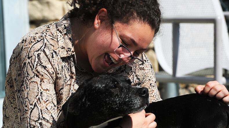 Doolis cuddles against Kara Hamby, a Montgomery County public information officer for the animal resource center. MARSHALL GORBY\STAFF