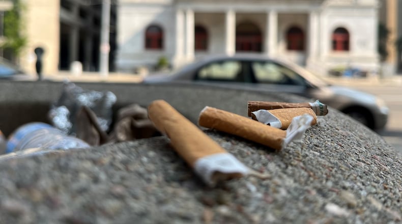 Cigarette butts on a trash can across from Dayton's City Hall. CORNELIUS FROLIK / STAFF