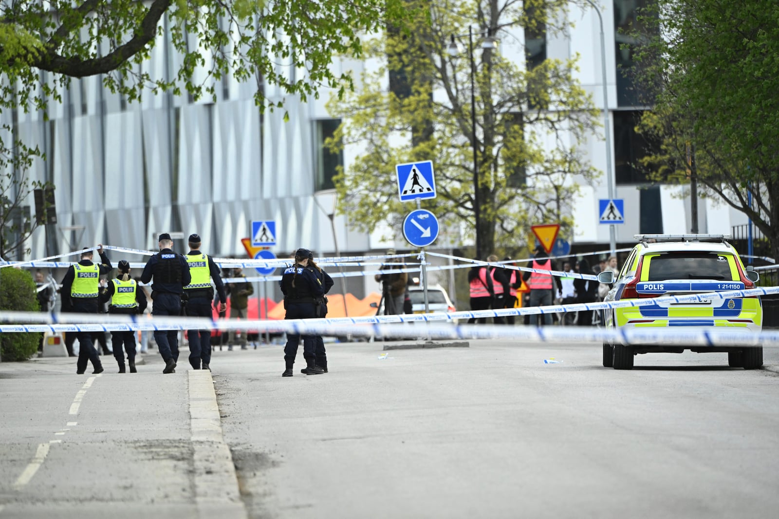 Police at the scene after a shooting incident, at Vaksala Square, in central Uppsala, Sweden, Tuesday, April 29, 2025. (Fredrik Sandberg/TT News Agency via AP)