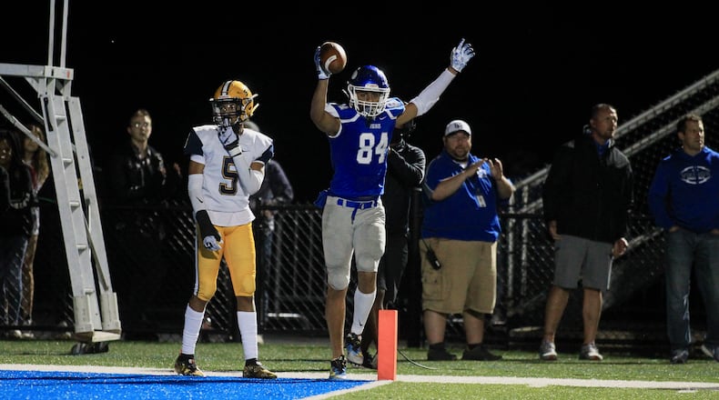 Miamisburg's Jackson McGohan celebrates the first of his three touchdowns against Springfield on Friday, Oct. 15, 2021, at Holland Field in Miamisburg. David Jablonski/Staff
