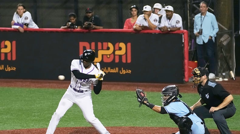 A Mumbai batter hits the ball during the league's opening baseball game against Karachi at the new Barry Larkin Field in Ud al-Bayda on the outskirts of Dubai, United Arab Emirates, Friday, Nov. 14, 2025. (AP Photo/Fatima Shbair)