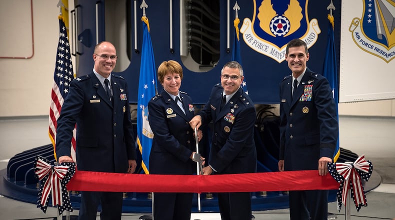 Col. Alden Hilton, United States Air Force School of Aerospace Medicine commander; Lt. Gen. Dorothy Hogg, Air Force surgeon general; Maj. Gen. William Cooley, Air Force Research Laboratory commander; and Brig. Gen. Mark Koeniger, 711th Human Performance Wing commander, pose just before cutting the ribbon during a ceremony Aug. 2 in USAFSAM to mark the full operational capability of the Department of Defense’s only human-rated centrifuge. (U.S. Air Force photo/Richard Eldridge)