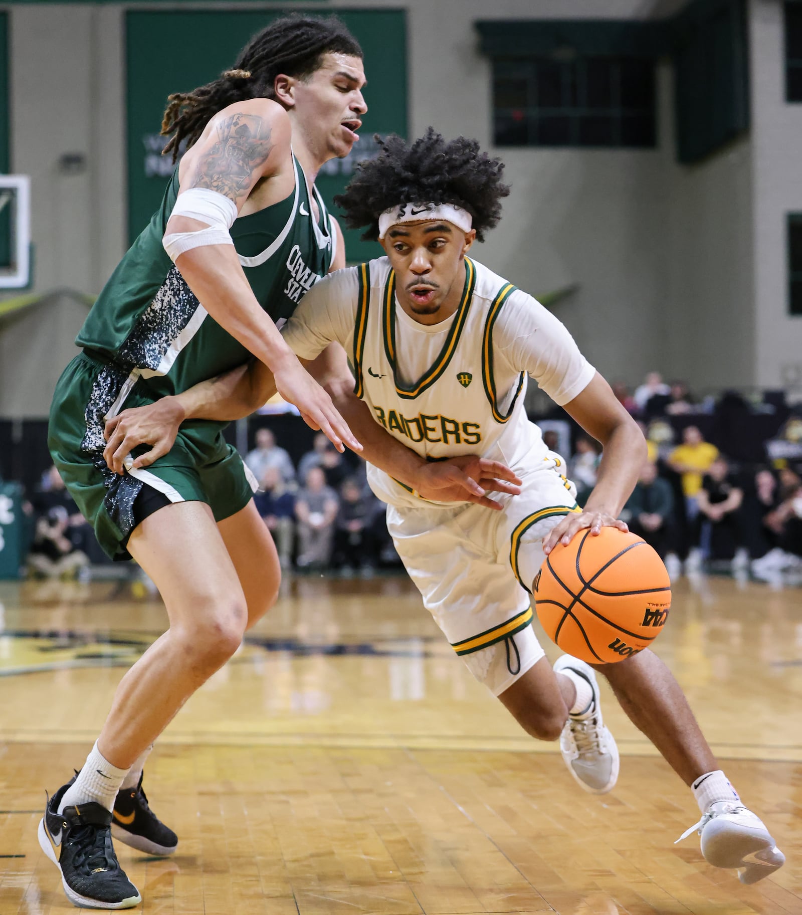 Wright State sophomore guard TJ Burch dribbles with pressure from Cleveland State's Preist Ryan during a Horizon League Championship first-round game on Wednesday, March 4 at Ervin J. Nutter Center in Fairborn. BRYANT BILLING / STAFF