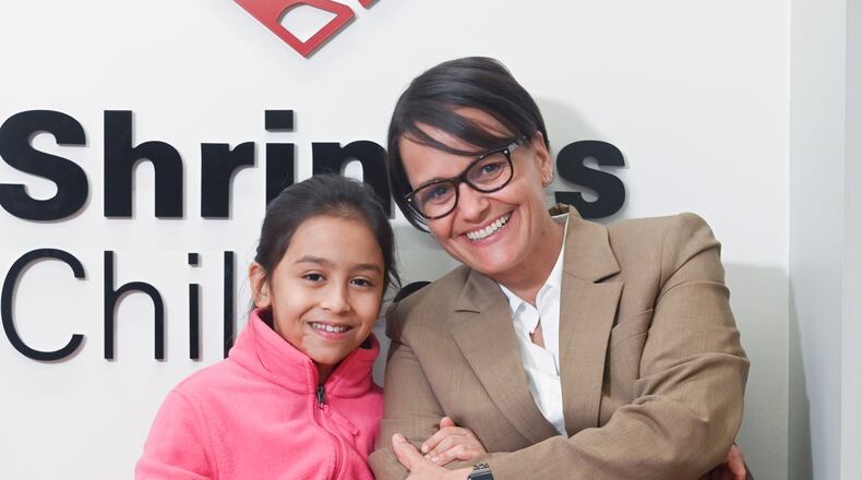 Dr. Sara Higginson, chief of staff at Shriners Children’s Ohio, poses with a burn patient at the Dayton location. PROVIDED