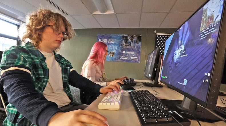 Regan Herzog, left, and Elise Hess, students at the Gobal Impact STEM Academy, play computer games in the school's esports computer lab Thursday, Feb. 2, 2023. BILL LACKEY/STAFF