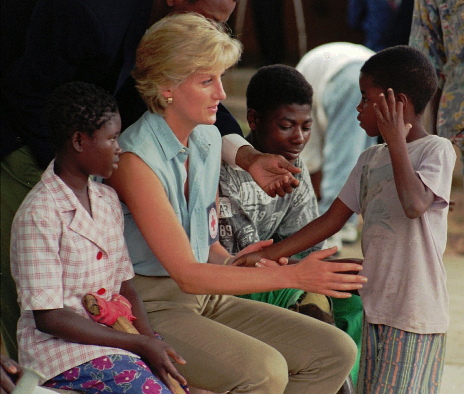 FILE - Diana, Princess of Wales, talks to young Angolan amputees who had their limbs severed by land mines at the the Neves Bendinha Orthopedic Workshop in the outskirts of Luanda, Angola, Jan. 14, 1997. (AP Photo/Giovanni Diffidenti, File)