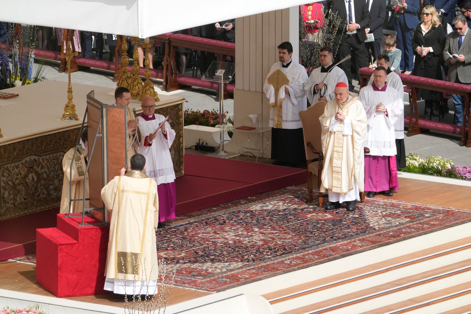 Cardinal Angelo Comastri, right, presides over the Easter mass in St. Peter's Square at the Vatican Sunday, April 20, 2025. (AP Photo/Gregorio Borgia)