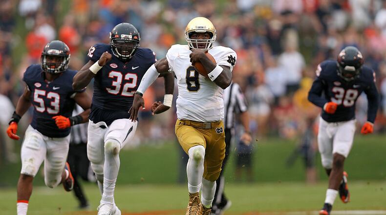 CHARLOTTESVILLE, VA - SEPTEMBER 12: Quarterback Malik Zaire #8 of the Notre Dame Fighting Irish rushes past defensive end Mike Moore #32 of the Virginia Cavaliers in the third quarter at Scott Stadium on September 12, 2015 in Charlottesville, Virginia. The Notre Dame Fighting Irish won, 34-27. (Photo by Patrick Smith/Getty Images)