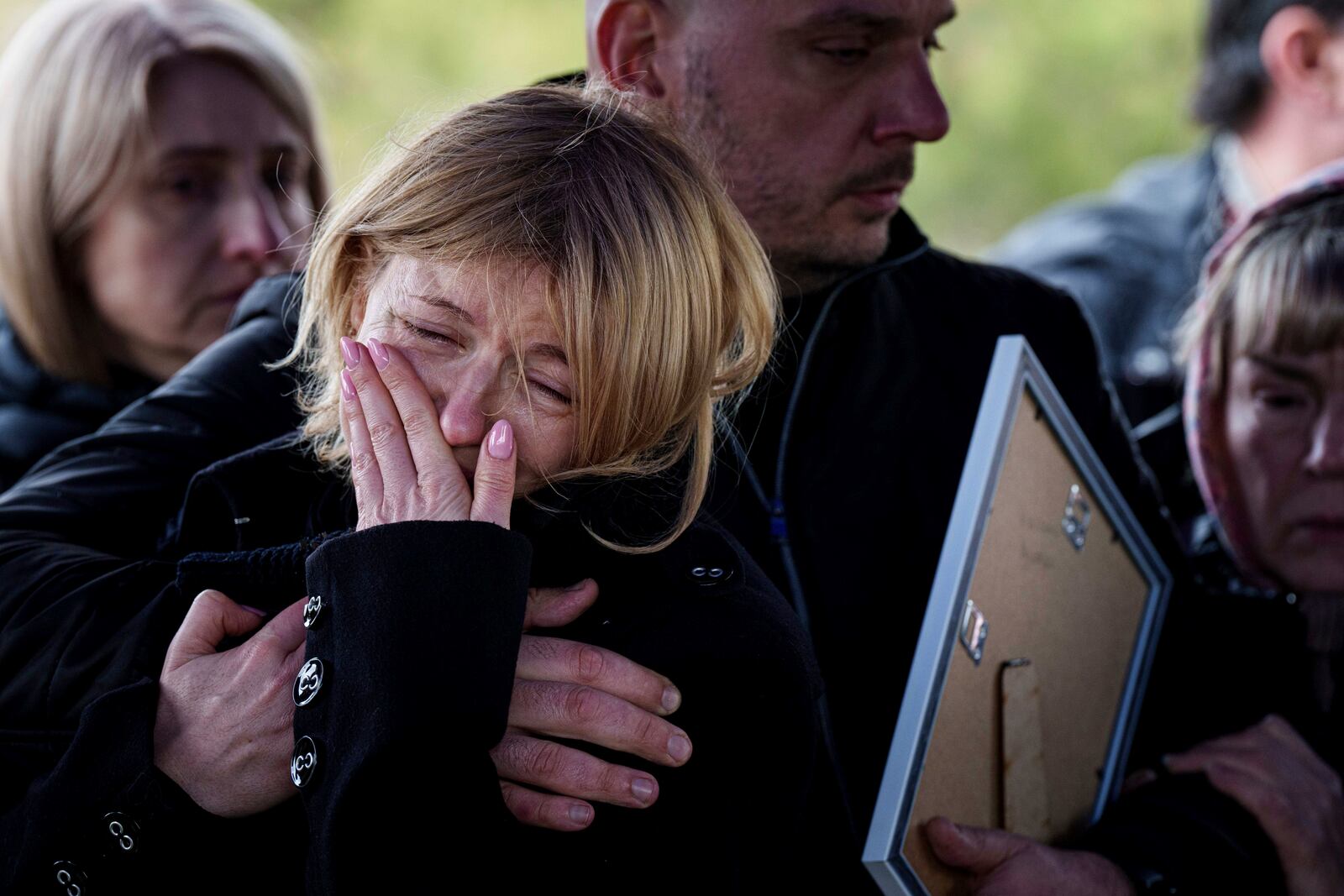A mother of Danylo Nikittskyi, 15, cries during a funeral ceremony of her son killed by a Russian missile in Kryvyi Rih, Ukraine, Monday, April 7, 2025. (AP Photo/Evgeniy Maloletka)