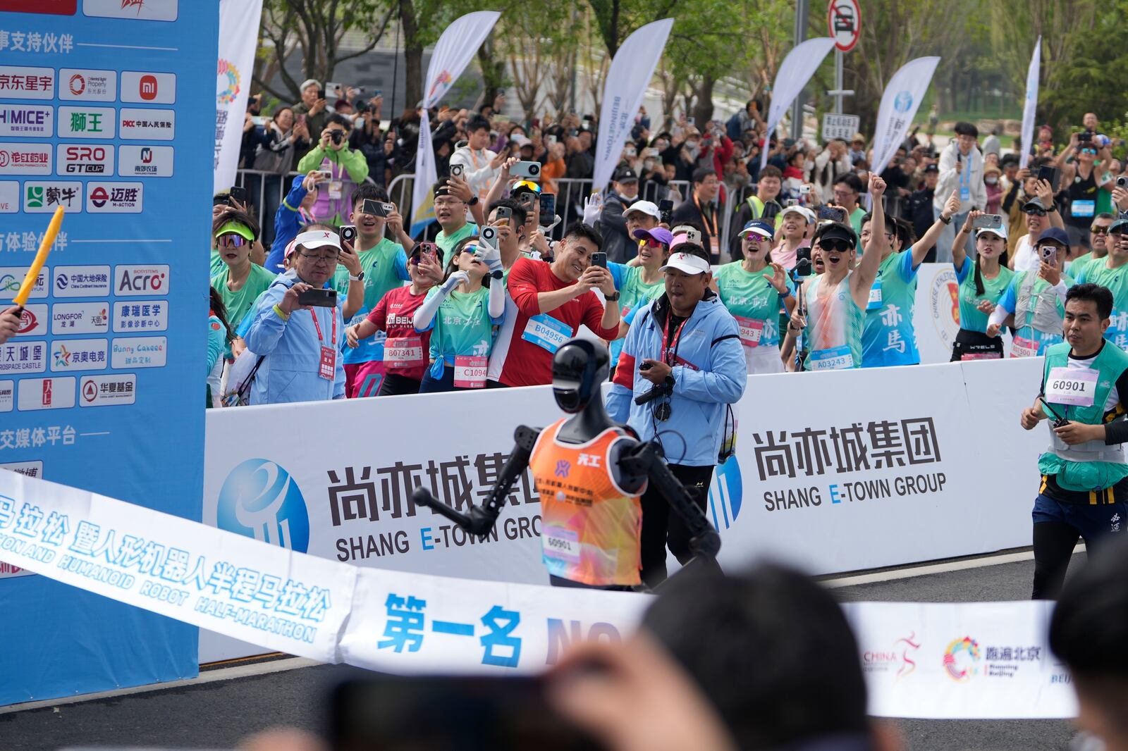 Sky Project Ultra robot crosses the finish line to win the world's first robot half marathon during the Humanoid Robot Half-Marathon held in Beijing on Saturday, April 19, 2025. (AP Photo/Ng Han Guan)