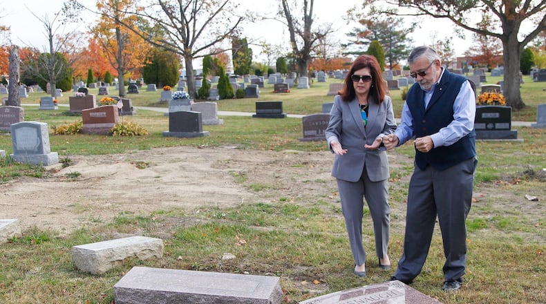 Mark Davis, general manager of Dayton Memorial Park in Butler Twp., describes the cemetery’s tornado damage to Anne Petit, superintendent for the Division of Real Estate and Professional Licensing at the Ohio Department of Commerce. The state division awarded the cemetery with one of the first grants in a new program. CHRIS STEWART / STAFF