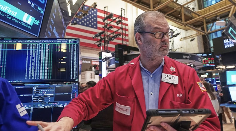 Trader William Lawrence works on the floor of the New York Stock Exchange, Friday, Feb. 13, 2026, in New York. (AP Photo/Richard Drew)