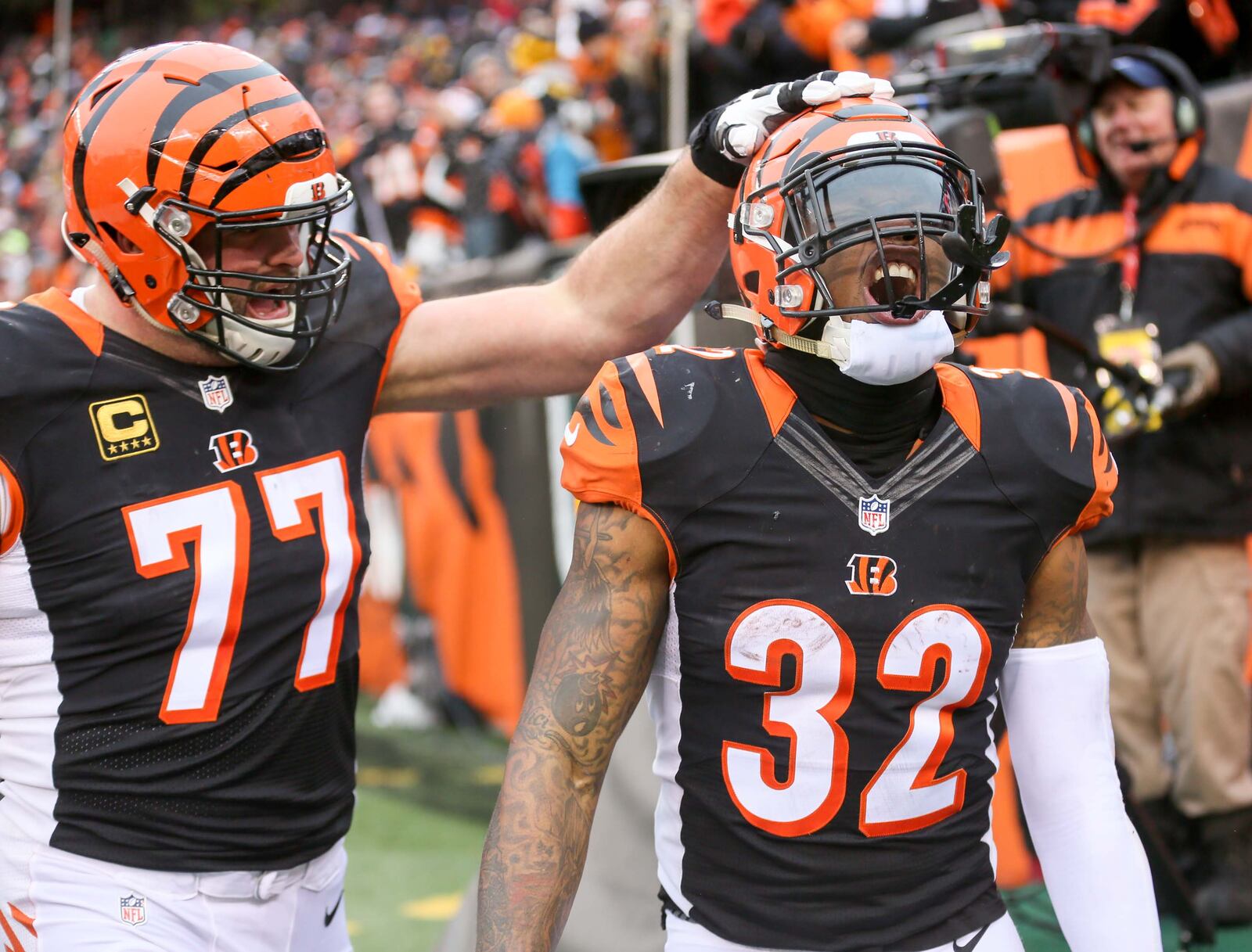 Bengals running back Jeremy Hill (32) celebrates a touchdown run with offensive tackle Andrew Whitworth (77) during their game against the Steelers at Paul Brown Stadium, Sunday, Dec. 18, 2016. GREG LYNCH / STAFF