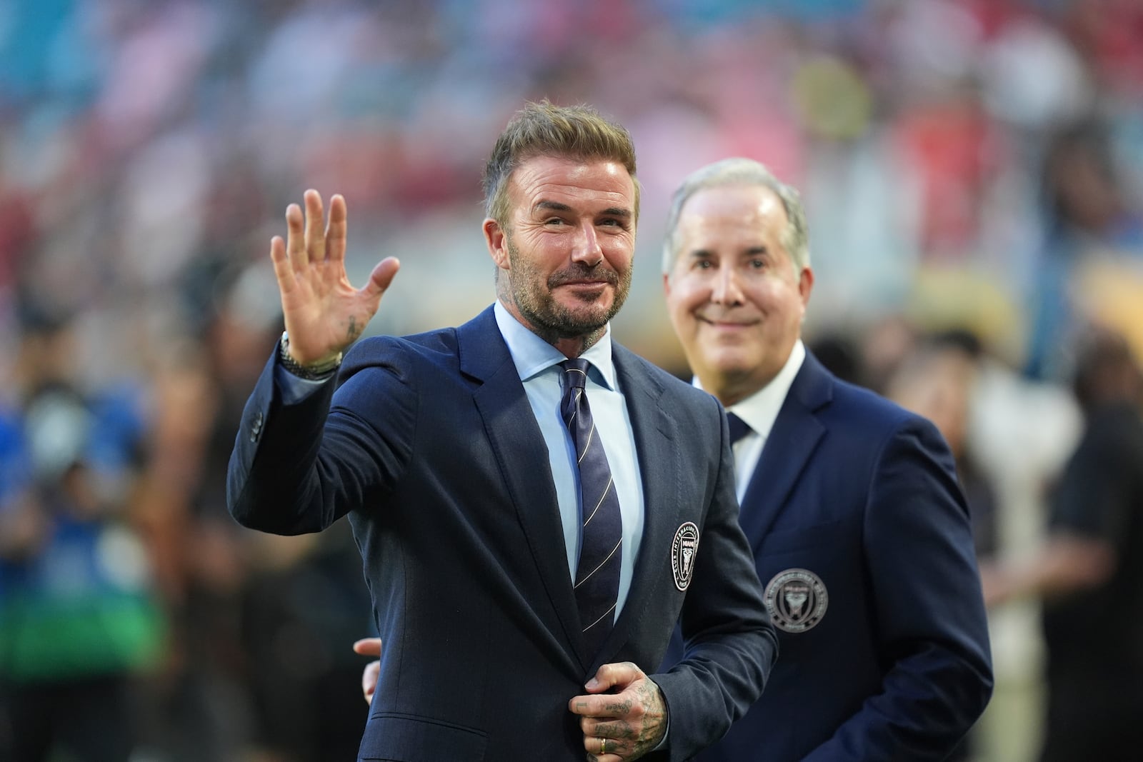 Inter Miami co-owner David Beckham, front, waves fans accompanied by managing owner Jorge Mas during the Club World Cup group A soccer match between Al Ahly and Inter Miami in Miami, Fla., Saturday, June 14, 2025. (AP Photo/Rebecca Blackwell)