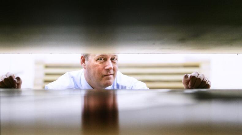 Composite Advantage President Scott Reeve looks between composite bridge decks in a 2010 photograph. His company’s building at 750 Rosedale Drive just sold for more than $1.6 million, local property records show. FILE