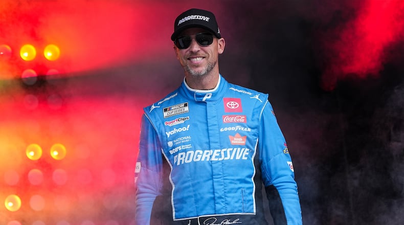FILE - Denny Hamlin smiles prior to a NASCAR Cup Series auto race at Charlotte Motor Speedway, Oct. 5, 2025, in Concord, N.C. (AP Photo/Matt Kelley, File)