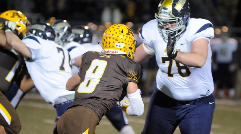 Alter junior Matt Schimpf (left, 6 feet 3, 200 pounds) takes on Norwalk junior Trey Leroux (6-8, 315). Alter defeated Norwalk 34-13 in a D-III state semifinal at Wapakoneta on Friday, Nov. 23, 2018. MARC PENDLETON / STAFF