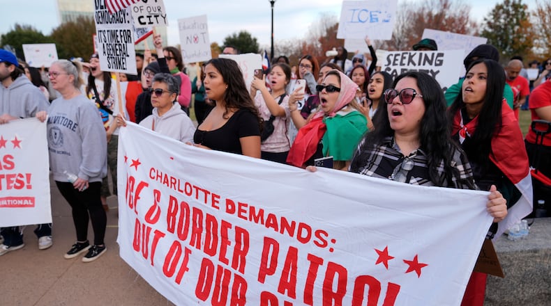 People protest against federal immigration enforcement Saturday, Nov. 15, 2025, in Charlotte, N.C. (AP Photo/Erik Verduzco)