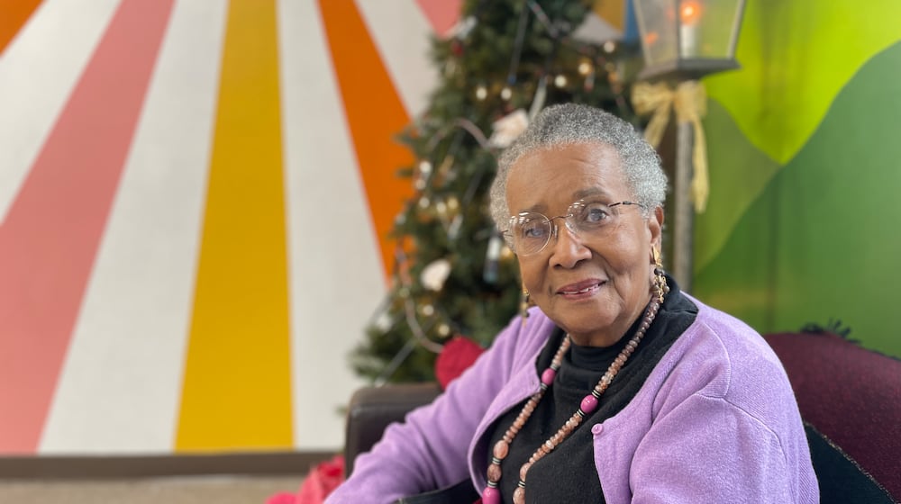 Lana Taylor, an artist-client at the nonprofit We Care Arts in Kettering, pictured at the nonprofit's Christmas party on Dec. 19, 2025. She has been taking classes at the nonprofit for about two years, which has helped her stay disciplined, helped with her healing and further cultivate her passion for art. SAM WILDOW/STAFF