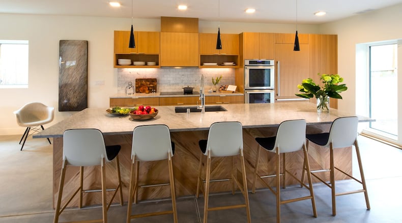 The sustainably harvested oak on the kitchen island forms a chevron pattern amid a neutral, low-maintenance aesthetic. It is not dated, says Dwell Development principal Anthony Maschmedt. Mixed metals are popular now, but we can t get caught up in trends. (Mike Siegel/The Seattle Times/TNS)