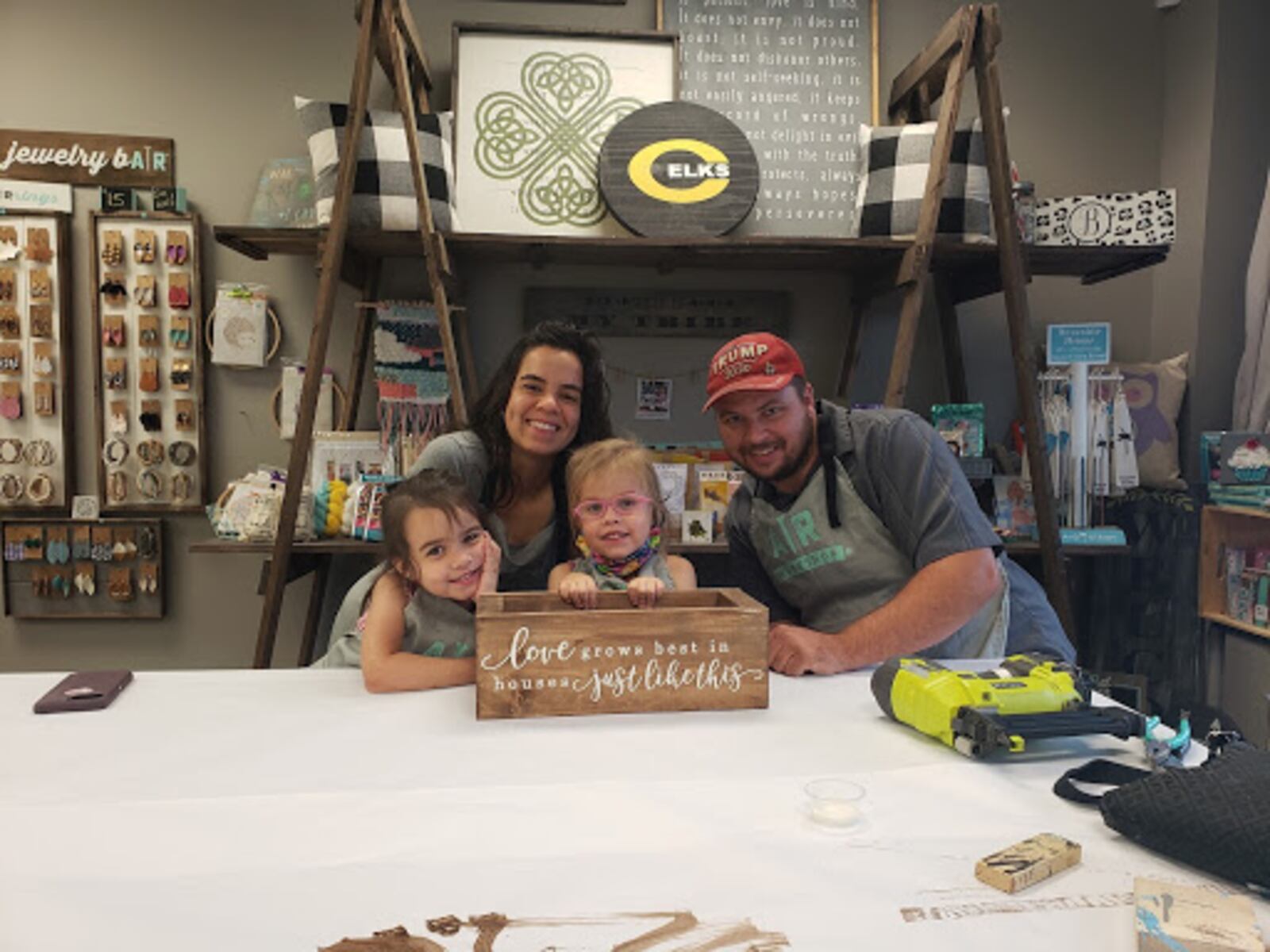 A family posing with a sign that they made at an AR Workshop Centerville event.