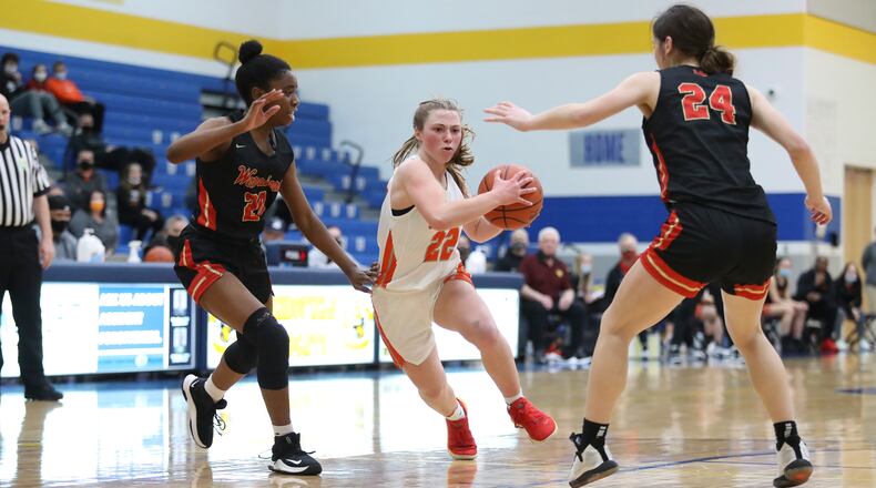 Waynesville High School junior Isabella Cassoni drives past Worthington Christian's Jaeda Tagoe (left) and Meghan Mayotte during their Division III regional semifinal game on Wednesday night at Springfield High School. The Warriors won 52-40. Michael Cooper/CONTRIBUTED