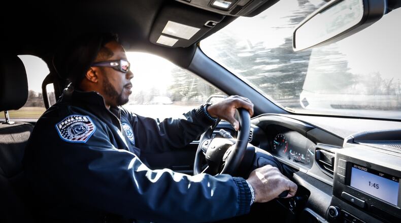 Beavercreek Police Officer, Kris Brownlee patrols a neighborhood near the station on Research Park Dr. JIM NOELKER/STAFF
