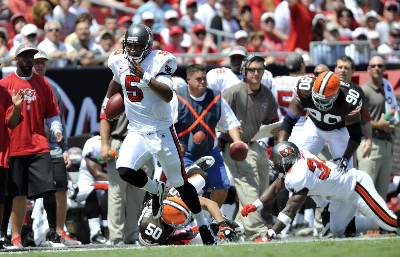 uccaneers quarterback Josh Freeman (5) eludes Cleveland Browns linebacker Eric Barton (50) during the first half.