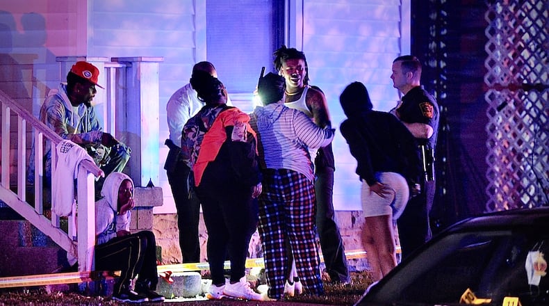 Residents are shown at the scene of mass shooting Sunday morning May 1, 2022. One person was fatally shot and four others were transported to hospitals with gunshot wounds.  MARSHALL GORBY \STAFF