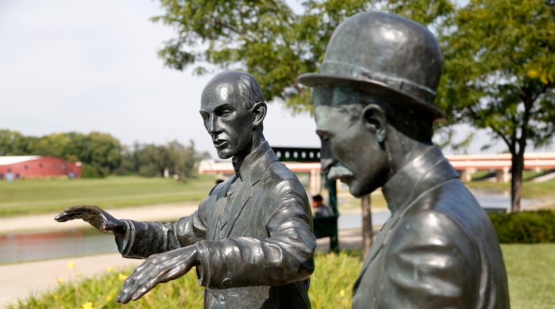 At Deeds Point, two life-sized statues of Orville and Wilbur Wright commemorate the beginnings of aircraft control. The statue captures Orville twisting a bicycle inner tube box as Wilbur explains his scheme for warping wings. LISA POWELL / STAFF