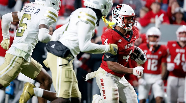North Carolina State running back Jayden Scott (4) runs the ball away from Georgia Tech defenders during the second half of an NCAA college football game in Raleigh, N.C., Saturday, Nov. 1, 2025. (AP Photo/Karl DeBlaker)