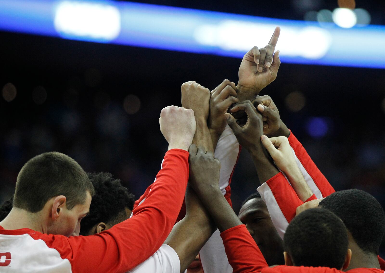 Dayton players huddle before a game against Oklahoma in the third round of the NCAA tournament on Sunday, March 22, 2015, at Nationwide Arena in Columbus. David Jablonski/Staff