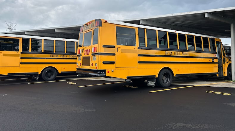 Buses in the Dayton Public Schools Transportation Center lot on James H. McGee Blvd. Eileen McClory/ staff