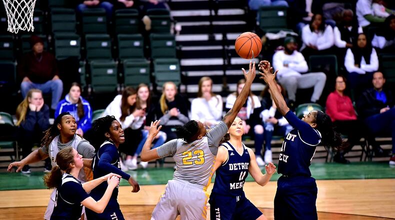 Wright State’s Symone Simmons reaches for a rebound among four Detroit Mercy players Sunday at the Nutter Center. Simmons, a senior guard, became the Raiders career leader in rebounds. Joseph Craven/CONTRIBUTED