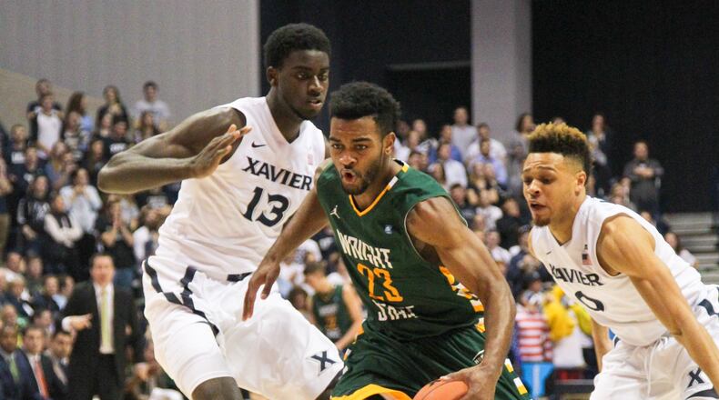 Wright State guard guard Mark Alstork (23) drives through Xavier defenders during their game against Xavier held at the Cintas Center at Xavier University in Cincinnati, Tuesday, Dec. 8, 2015. GREG LYNCH / STAFF