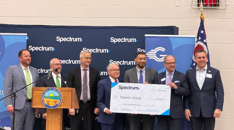 Ohio Governor Mike DeWine and leaders from the Dayton Development Coalition and Spectrum internet celebrate a milestone in the company's rural broadband expansion project. LONDON BISHOP/STAFF