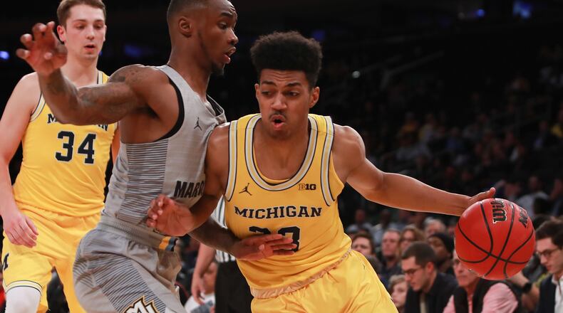 Michigan's Ibi Watson, right, drives in the lane on Marquette's Traci Carter during the 2K Classic at Madison Square Garden on November 17, 2016 in New York City.  (Photo by Michael Reaves/Getty Images)